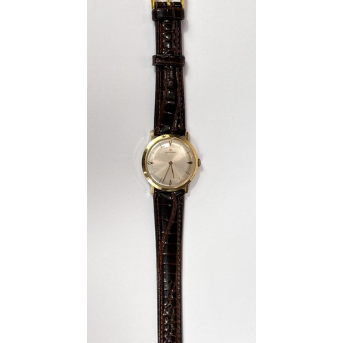 613 - BUCHERER: a c. 1970 Swiss manual watch with silver dial, gold hands and batons, case stamped 18K 750... 