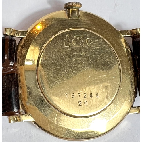 613 - BUCHERER: a c. 1970 Swiss manual watch with silver dial, gold hands and batons, case stamped 18K 750... 