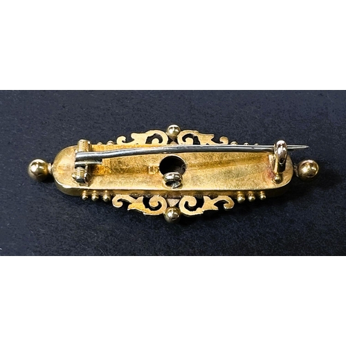 634 - An Edwardian yellow metal bar brooch with scroll and filigree decoration, set small diamond, stamped... 