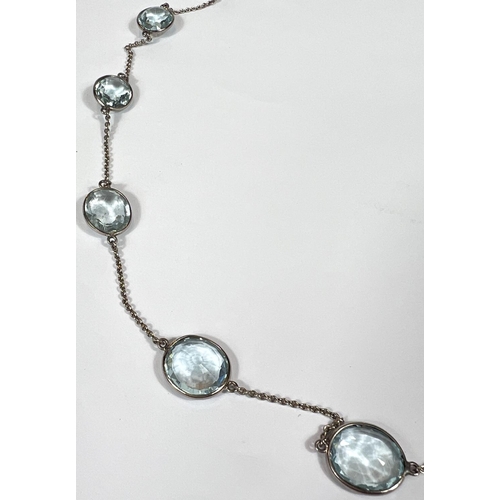 666 - An Art Deco white gold spectacle chain necklace, stamped '18ct' with 22 graduating aquamarine  stone... 