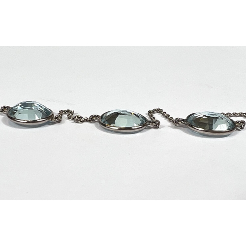 666 - An Art Deco white gold spectacle chain necklace, stamped '18ct' with 22 graduating aquamarine  stone... 