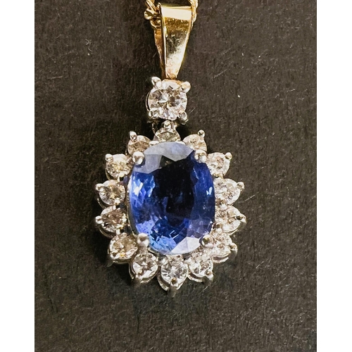 668 - A sapphire and diamond pendant, central sapphire surrounded by diamonds on 18k gold chain 4.7gms