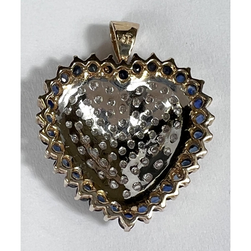 670 - A 14k yellow and white gold heart shaped pendant encrusted with diamonds surrounded by sapphires