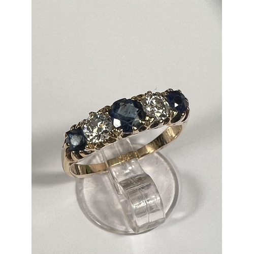 693 - A Victorian style yellow metal ring set 3 alternating sapphires and 2 diamonds, stamped '18ct', cent... 