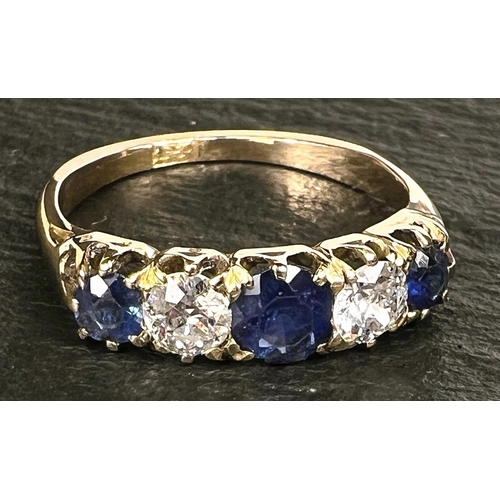 693 - A Victorian style yellow metal ring set 3 alternating sapphires and 2 diamonds, stamped '18ct', cent... 