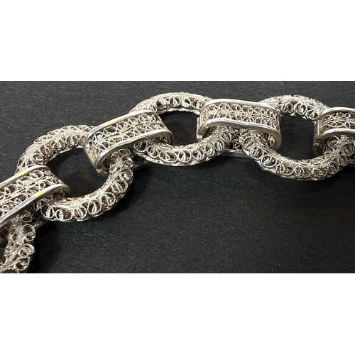 694 - A white metal bracelet formed from circular filigree links