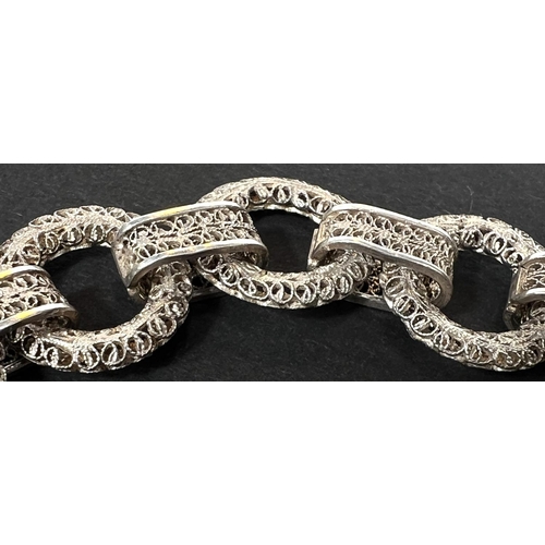 694 - A white metal bracelet formed from circular filigree links