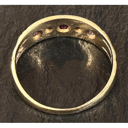 707 - An 18 carat hallmarked gold gypsy ring set 3 small rubies and 2 diamonds, size N, 3gm