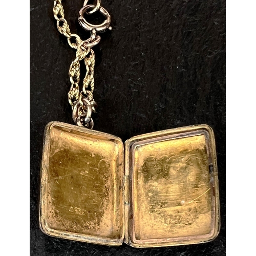 711 - A 9 carat hallmarked gold rectangular locket with chased decoration, on rope twist chain stamped 9ct... 