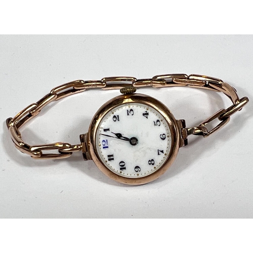 715 - An early 20th century lady's wristwatch in 9 carat hallmarked gold, on extending bracelet, stamped '... 