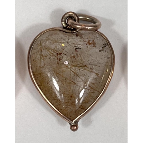 723 - A 9 carat hallmarked gold heart shaped locket/pendant with sapphire coloured stone, 1gm; a rock crys... 