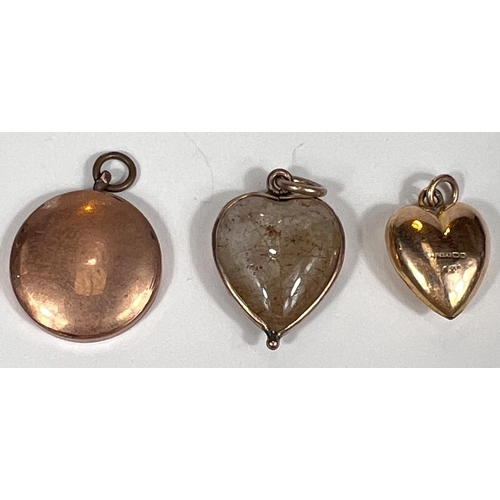 723 - A 9 carat hallmarked gold heart shaped locket/pendant with sapphire coloured stone, 1gm; a rock crys... 