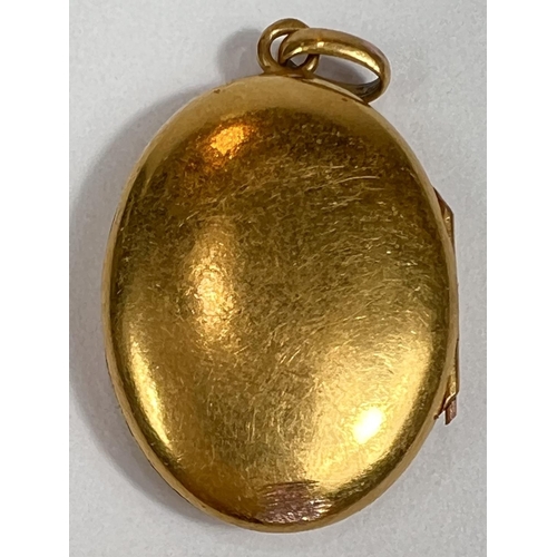 724 - A yellow metal oval pendant locket, monogrammed,  unmarked, tests as circa 18ct, 4.5gm