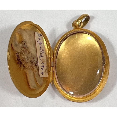 724 - A yellow metal oval pendant locket, monogrammed,  unmarked, tests as circa 18ct, 4.5gm