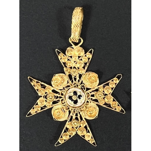 725 - A yellow metal filigree Maltese cross with central enamel boss; a similar smaller pendant, tests as ... 