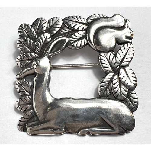 727 - Georg Jensen: A square openwork brooch with resting deer and squirrel in foliage, designed by Arno M... 