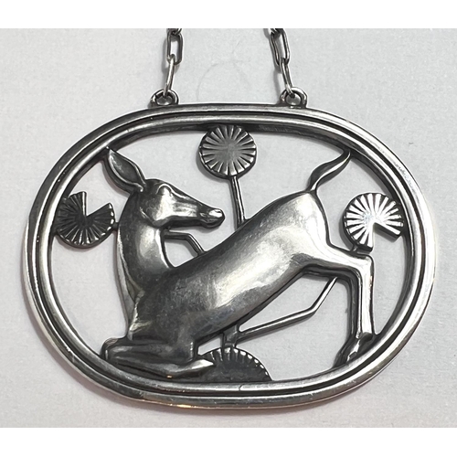 728 - Georg Jensen: an oval openwork silver pendant with deer kneeling amongst foliage, stamped GJ, 9255 S... 