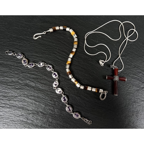 733 - A modern cornelian crucifix set marcasite; a tiger's eye bead bracelet; and another, all marked 925