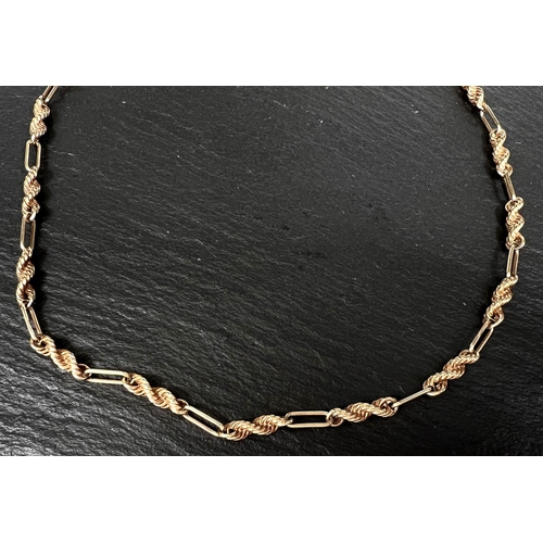 734 - A rope twist and open link neck chain in 9 carat gold, 24.9gm