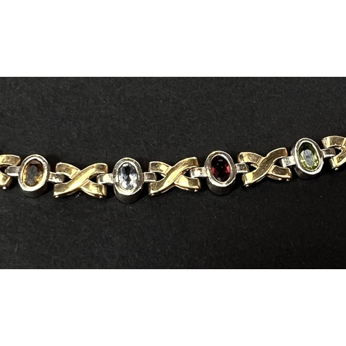 735 - A 9 carat gold crosslink bracelet set faceted coloured stones, 14.7gm gross