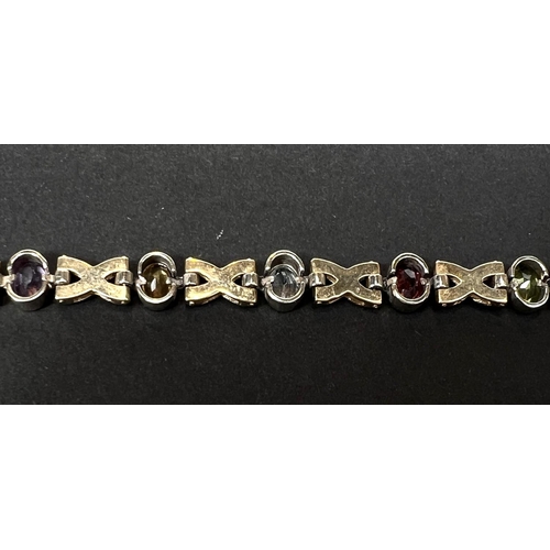 735 - A 9 carat gold crosslink bracelet set faceted coloured stones, 14.7gm gross