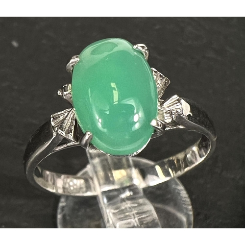 737 - A dress ring set pale green jade cabochon, white metal shank stamped '18k', 2.8gm