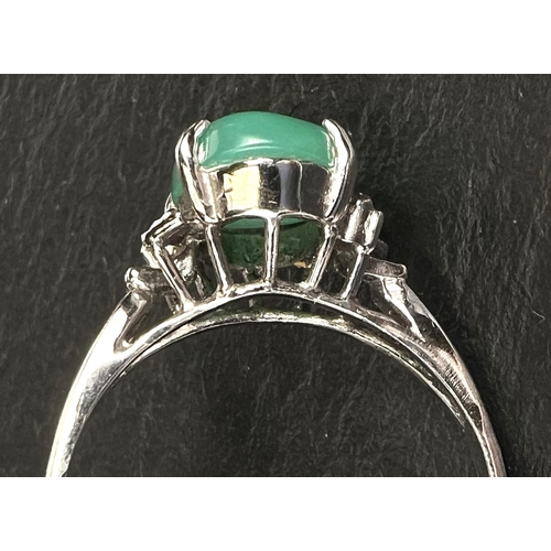 737 - A dress ring set pale green jade cabochon, white metal shank stamped '18k', 2.8gm