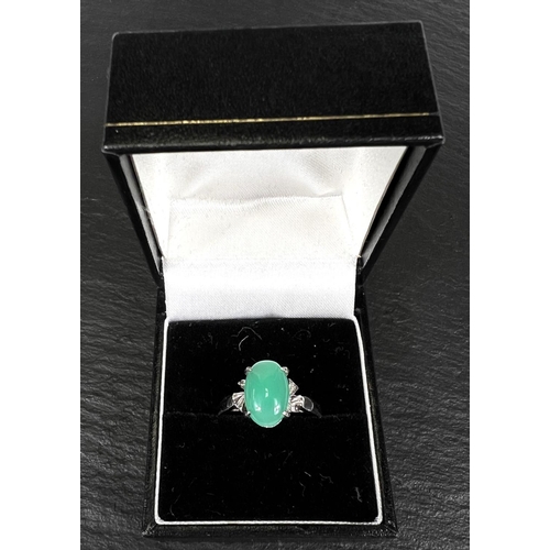 737 - A dress ring set pale green jade cabochon, white metal shank stamped '18k', 2.8gm