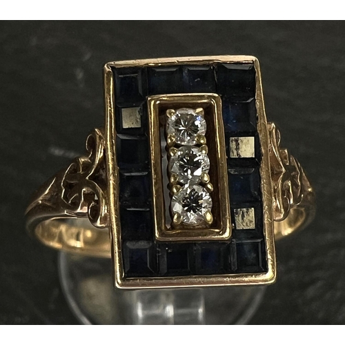 742 - An Art Deco dress ring set 3 diamonds and pave set border of square sapphires, 18 carat gold shank