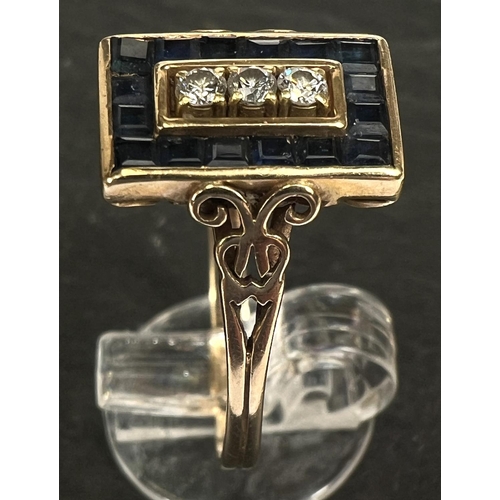 742 - An Art Deco dress ring set 3 diamonds and pave set border of square sapphires, 18 carat gold shank