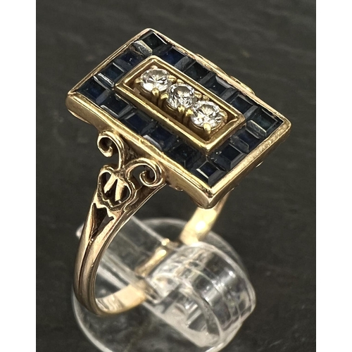 742 - An Art Deco dress ring set 3 diamonds and pave set border of square sapphires, 18 carat gold shank