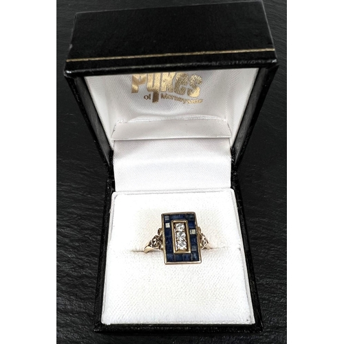 742 - An Art Deco dress ring set 3 diamonds and pave set border of square sapphires, 18 carat gold shank