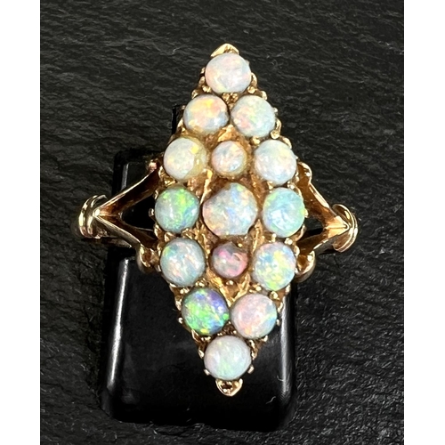 743 - A marquise shaped dress ring set 15 opal beads in yellow gold shank, stamped '15ct'