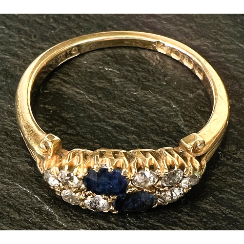 744 - A ladies dress ring set 2 sapphires and 8 diamonds, 18 carat gold shank