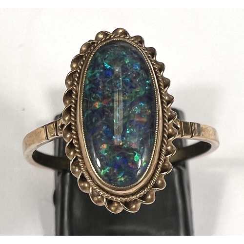 749 - A 9 carat gold dress ring set black opal effect cabochon with rope twist border, size T