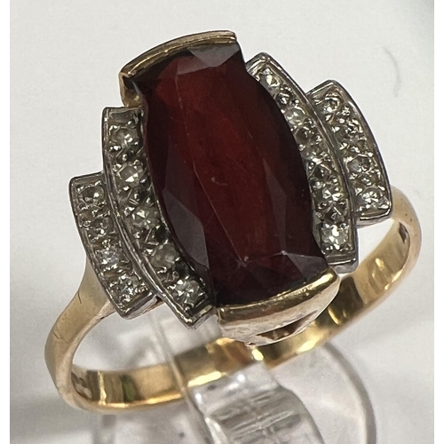 753 - An Art Deco style dress ring set garnet surrounded by 18 small diamonds, 18 carat yellow gold shank,... 