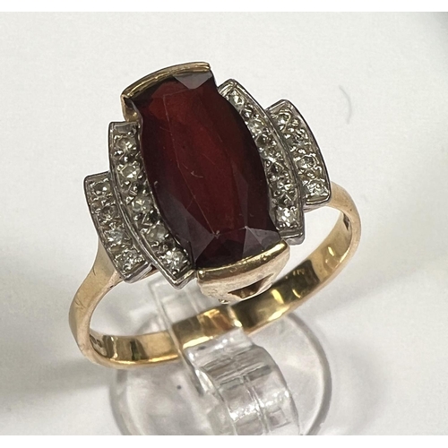 753 - An Art Deco style dress ring set garnet surrounded by 18 small diamonds, 18 carat yellow gold shank,... 