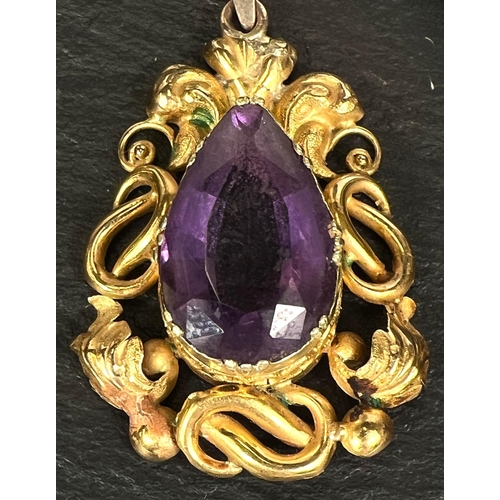 754 - A Victorian pendant in gold foil scrollwork, set amethyst, tests as 9ct, 3.5cm