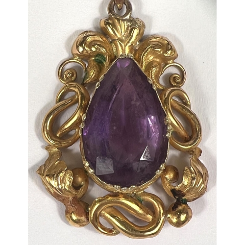 754 - A Victorian pendant in gold foil scrollwork, set amethyst, tests as 9ct, 3.5cm