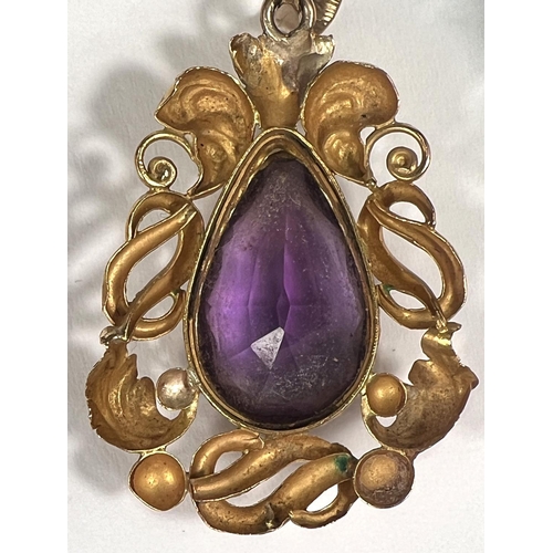 754 - A Victorian pendant in gold foil scrollwork, set amethyst, tests as 9ct, 3.5cm