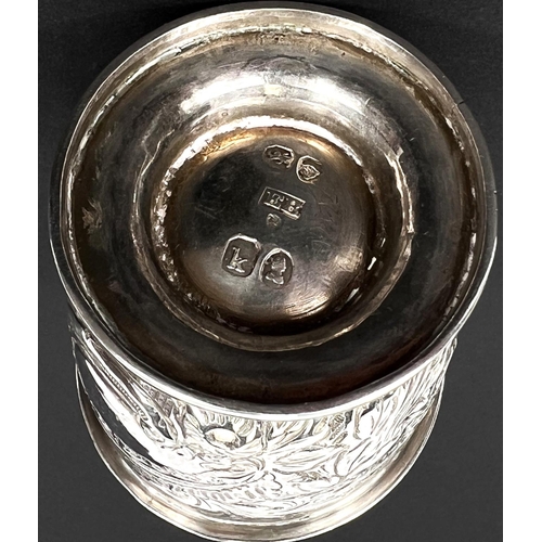 778 - A late Georgian silver muffineer, cylindrical form with repousse decoration and domed top, on pedest... 