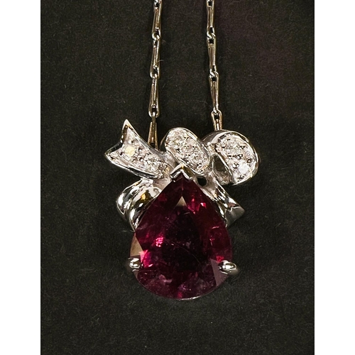 791 - An 18 carat white gold pendant necklace set with large tear drop shaped ruby with diamond above on 1... 