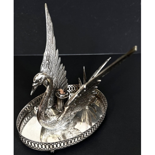 792 - A silver plated swan shaped bandy warmer with central light.