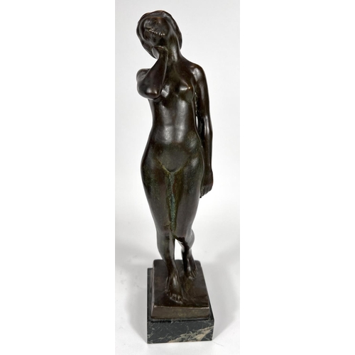 831 - Van de Voorde (1878-1970):  bronze female nude standing holding her neck, on marble base, signed, he... 