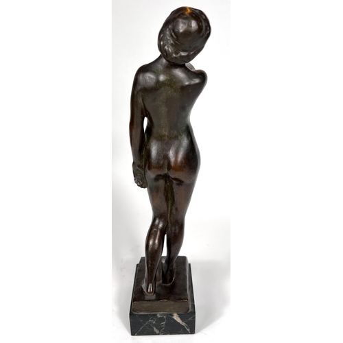 831 - Van de Voorde (1878-1970):  bronze female nude standing holding her neck, on marble base, signed, he... 