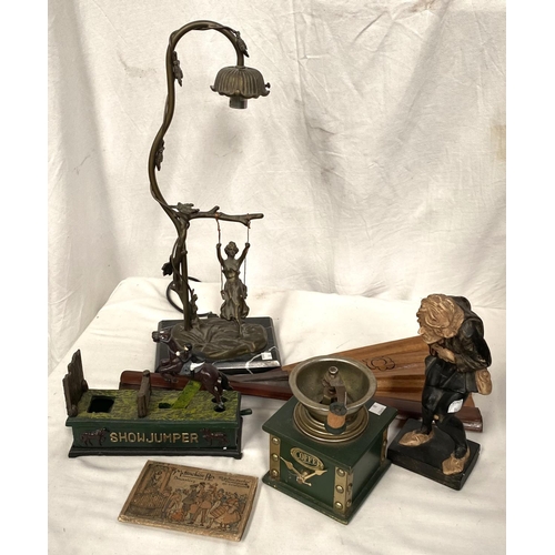 86 - A gilt metal table lamp with girl on a swing; a Victorian style cast iron money box; a coffee grinde... 