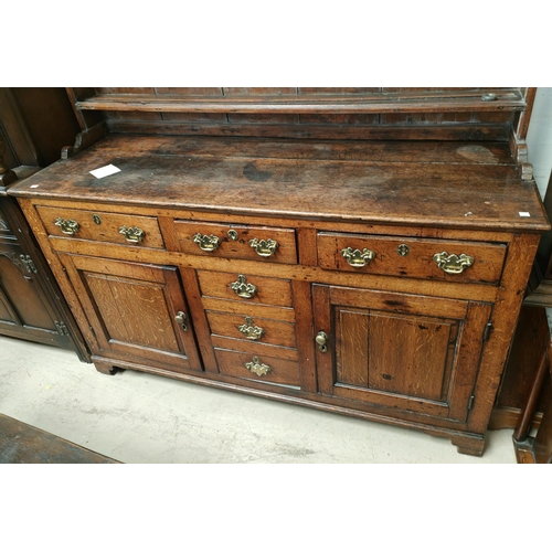 904 - An 18th century Country made Welsh dresser with 3 height delft rack over 3 frieze drawers, 2 side cu... 