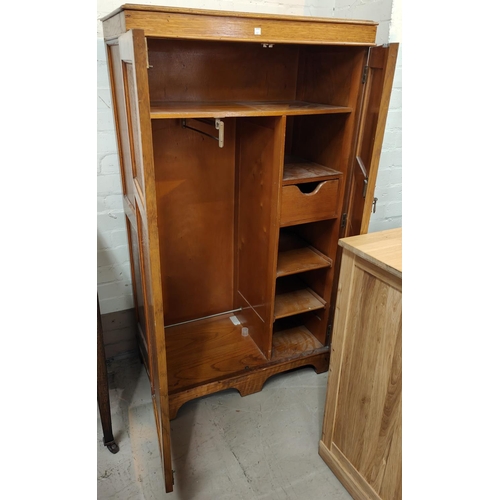 907 - A 1930's gent's golden oak wardrobe with 2 drawers, part fitted