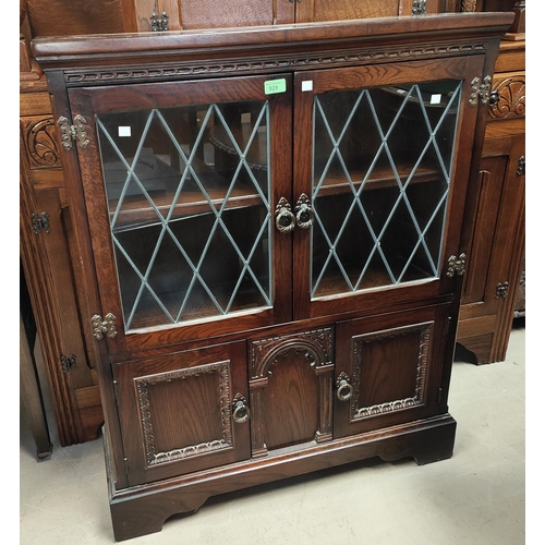 929 - An oak side cabinet with leaded glass double doors