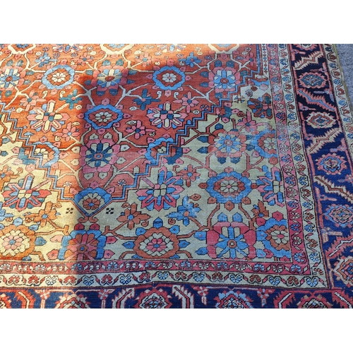 939A - A 19th century cream and red ground hand knotted Persian carpet with multiple borders and large cent... 